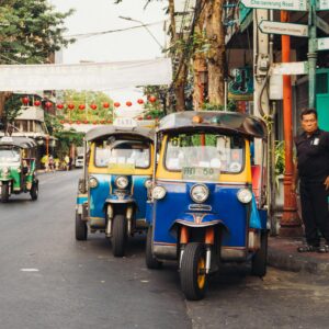 Man Standing Beside Parked Trikes